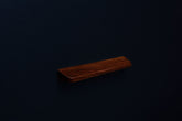 Top corner perspective of an American walnut wood handle showing natural grain and rounded edge